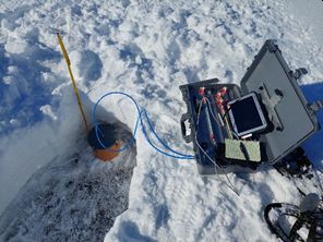 image of a snow pit with instruments around the edge